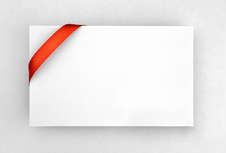 Red silk ribbon on empty paper cardの写真素材