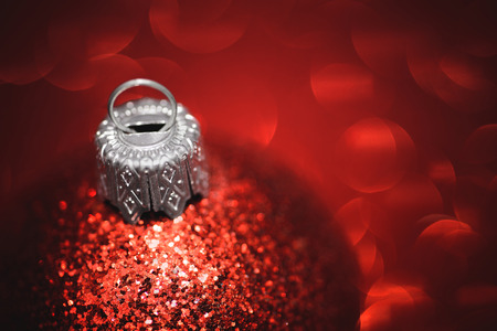 Red christmas ball close-up on glitter backgroundの写真素材