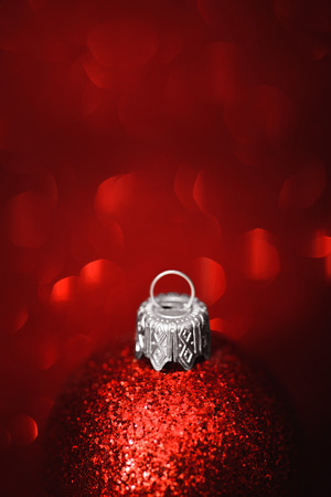 Red christmas ball close-up on glitter backgroundの写真素材