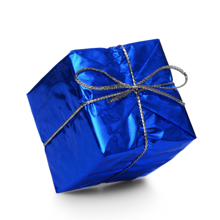 Blue gift with a silver ribbon and a bow falling on white backgroundの写真素材