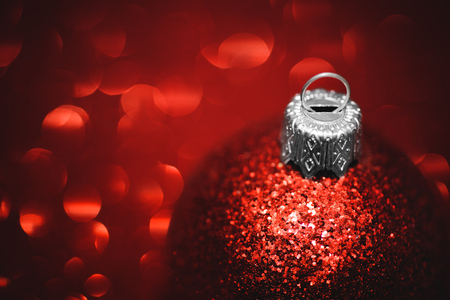 Red christmas ball close-up on glitter backgroundの写真素材