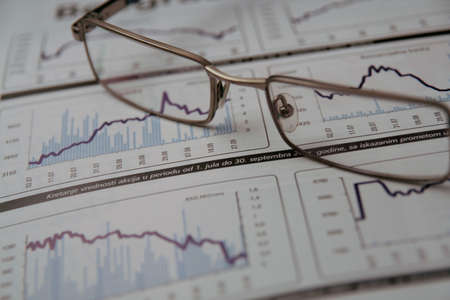Glasses on the stock chartの写真素材