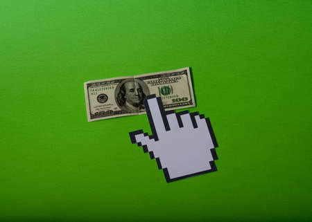 hand cursor over the hundred dollar billの写真素材