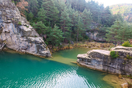 Beautiful landscape with a lake and rocks in the forest in the mountainsの写真素材