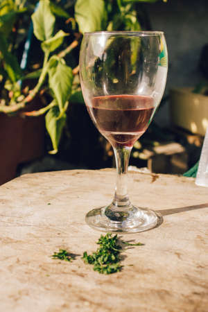 A glass of wine surrounded by nature in the outsideの写真素材