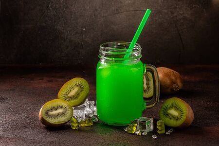 Delicious icy cocktail with fruits on dark grounge background. Healthy colorfull fruit shakes with ice on textured table.の写真素材