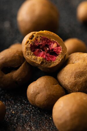 Sweet spiced handcrafted pralines on rustic textured dark background.の写真素材