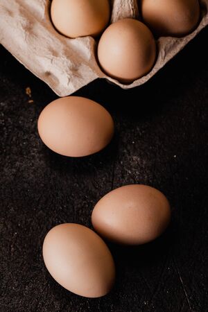 Fresh organic chicken eggs from the farm on dark grunge background