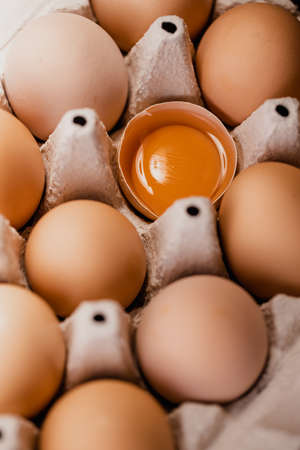 Fresh chicken eggs in carton egg tray or wood boxes