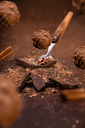 levitated chocolate pralines ON BROWN GROUNGE BACKGROUNDの写真素材