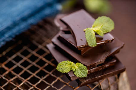 dark or milk chocolate bars with green mint leafの写真素材