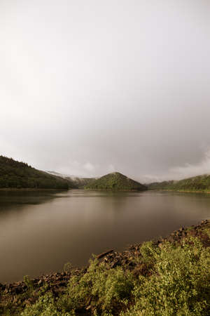 Mirror smooth water of the carpathian Zetelaka lake. Beautyful landscape after rainの写真素材