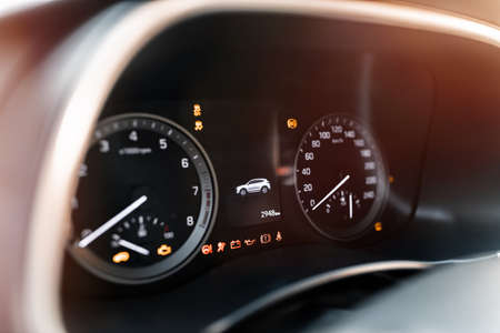 Close up of brand new car instrument panel with odometer, speedometer and fuel level meter. Car...