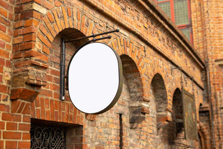 Empty singboard mockup on the wall of old brick building in Gdansk, the beutiful polish city