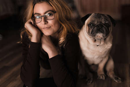 beautiful young blonde female model with pugの写真素材