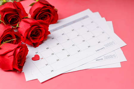 Valentine day. Red hearths and roses on Calendar page. February 14 of Saint Valentines day. Pink background.の写真素材