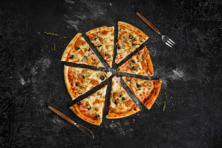 flat lay pizza slices vith tasty ingredients like mushroom, cheese and olives.の写真素材