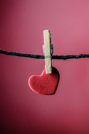 miniature red hearth hanging on clothespins with miniature wood clips