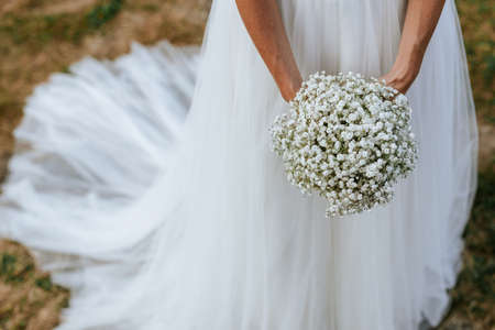 Closeup of hands of a bride holding her beautiful wedding bouquet