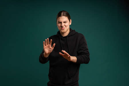 disgusting expression of a young man. Cropped studio portrait of male mood