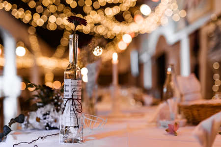 Table setting for wedding party decor flowers lights blurred backgroundの写真素材