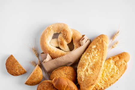 Freshly baked different bakery products with wheat on light gray backgroundの写真素材