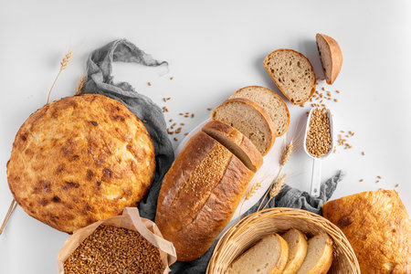 Homemade delicious freshly baked heathy natural bread food group on gray backgroundの写真素材