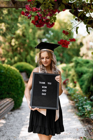 Graduation concept. Portrait of a young pretty blonde girl after medical universityの写真素材