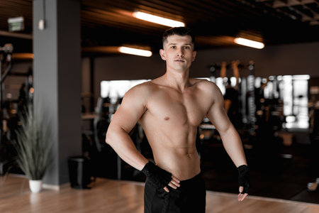 young Bodybuilder and Personal Trainer Working Out in a Modern, Well-Equipped Gymの写真素材