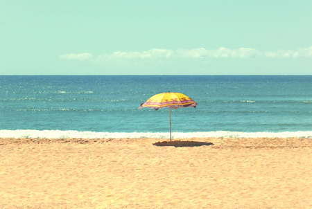 White sandy beach, sea and blue sky with umbrellaの写真素材