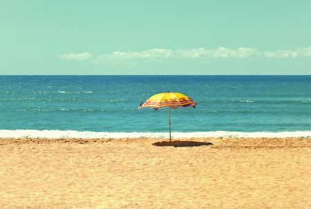 White sandy beach, sea and blue sky with umbrellaの写真素材