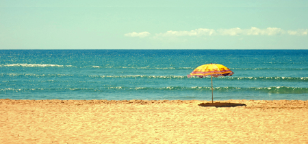 White sandy beach, sea and blue sky with umbrellaの写真素材