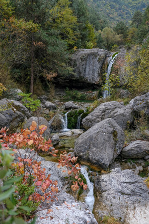 Autumn landscape with waterfall and rocks in the forest, Beautiful landscape in an evening mood by the water in the sunshine.の写真素材