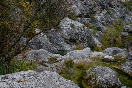 Mountain river in the mountains. Stones and water in the mountains. Beautiful landscape in an evening mood by the water in the sunshine.の写真素材