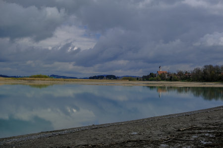 Landscape of a lake with a church in the background,Beautiful landscape in an evening mood by the water in the sunshine.の写真素材