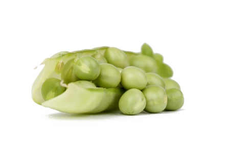 Pods of green peas with leaves on white background の写真素材