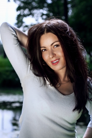 Beautiful and sexy young woman outdoors in a park setting.の写真素材