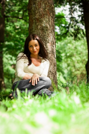 portrait of young brunette in the summer gardenの写真素材