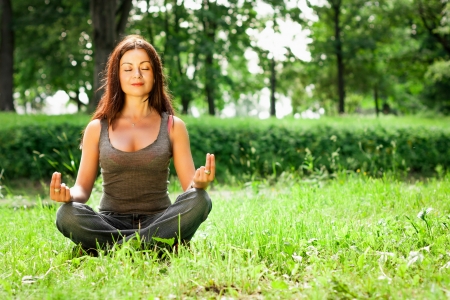 yoga woman on green parkの写真素材