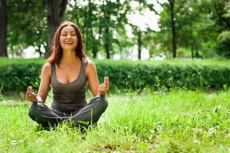yoga woman on green grassの写真素材