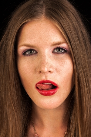 sexy fashion girl with red lipstick lick her lips with tongueの写真素材