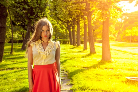Portrait of young beautiful woman in parkの写真素材