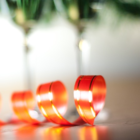 red ribbon and a two champagne glassesの写真素材