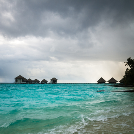 Over water bungalows with steps into amazing green lagoonの写真素材