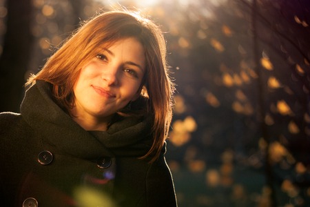 Portrait of young beautiful woman on green background summer nature.の写真素材