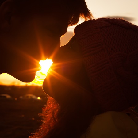 Silhouette of young man and woman in loveの写真素材