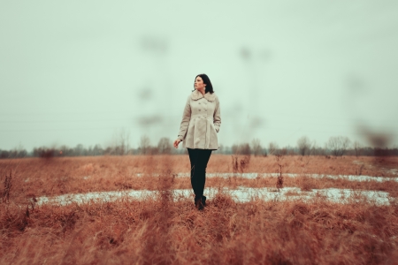 Young girl walking on grass fieldの写真素材