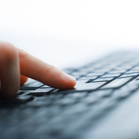 Close-up of typing male hands on keyboardの写真素材