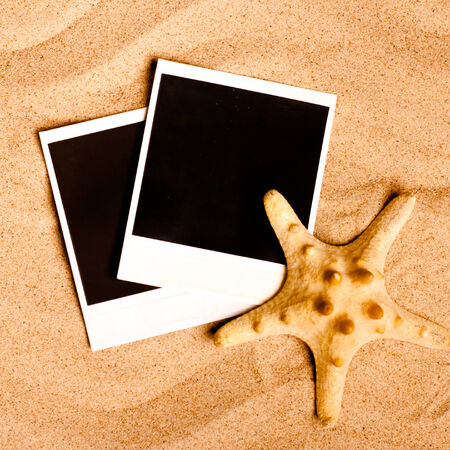 Instant photo frames on the beach with seashells around