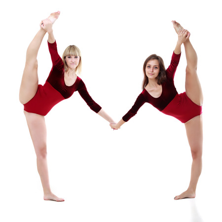 two women dance on a white background. studio shotの写真素材